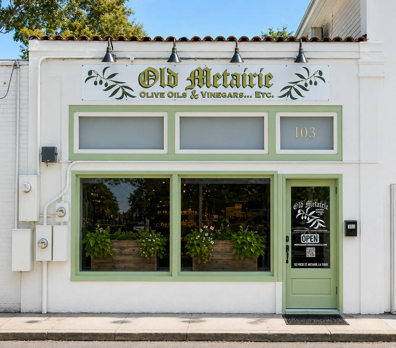 Olive oil store Metairie Louisiana storefront with green trim and Mediterranean style exterior