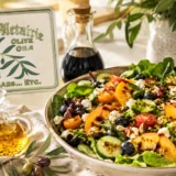 Fresh summer salad with peaches, berries, olive oil, balsamic vinegar, and Old Metairie Olive Oils and Vinegars in Metairie Louisiana